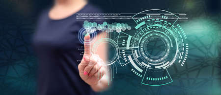 Woman touching a technology concept on a touch screen with her fingerの写真素材