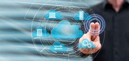 Man touching a cloud computing concept on a touch screen with his fingers