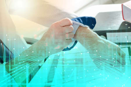 Businessman rolling up his sleeve at office; multiple exposure
