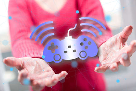 Online gaming concept above the hands of a woman in background