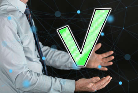 Validation concept above the hands of a manの写真素材