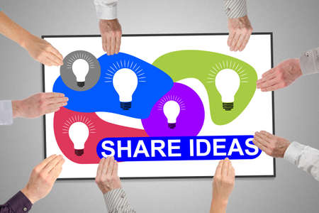 Share ideas concept on a whiteboard held by handsの写真素材