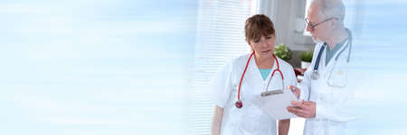 Two doctors discussing about medical report in clinic; panoramic banner
