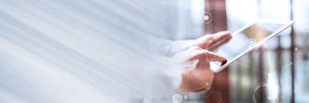 Businessman using tablet, hard light effect, double exposure with network; panoramic banner