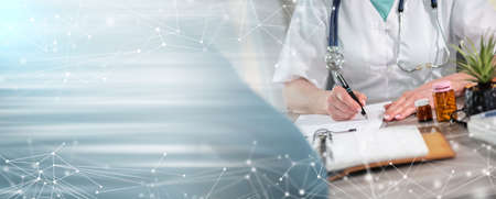 Female doctor writing prescription to her patient in medical office; panoramic banner
