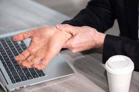 Businessman suffering from wrist painの写真素材