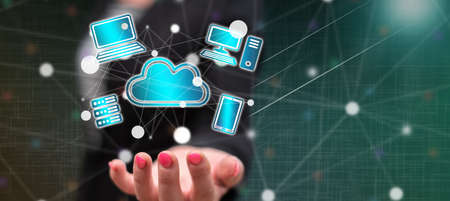 Cloud computing concept above the hand of a woman in background