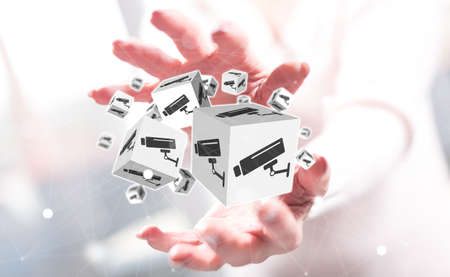 Security camera concept between hands of a woman in background