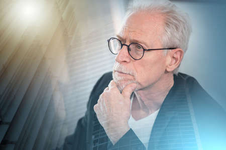 Portrait of thoughtful senior businessman with hand on chin; multiple exposure