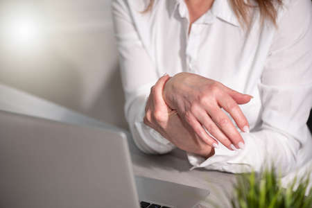 Businesswoman suffering from wrist painの写真素材