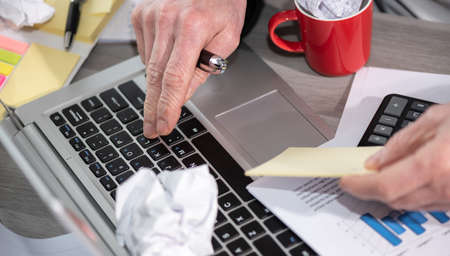 Businessman working on a cluttered and messy desk