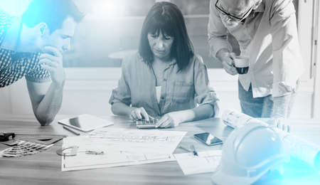 Architects working on plans at office, light effect