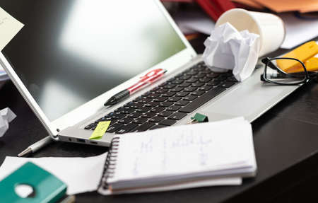Messy and cluttered office desk