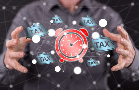 Tax time concept between hands of a man in background