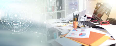 Messy and cluttered office desk, light effect; panoramic banner