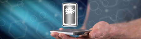 Message concept above a smartphone held by a man