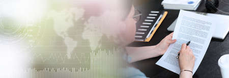 Businesswoman checking document in office; panoramic banner
