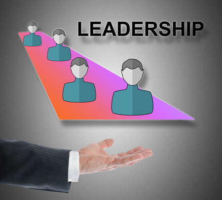 Leadership concept levitating above a hand on gray backgroundの写真素材