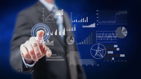 Man touching a financial analysis concept on a touch screen with his fingers
