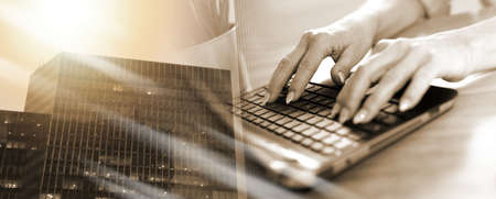 Female hands typing on laptop; multiple exposure