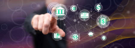 Man touching a mobile banking concept on a touch screen with his fingerの写真素材