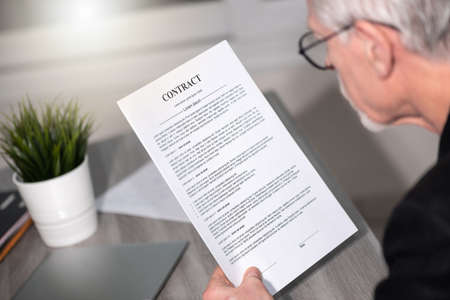 Senior man checking content of a contract