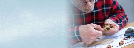 Plumber preparing fitting sealing with hemp fibers; panoramic bannerの写真素材