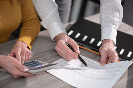 Coworkers working on financial data in office
