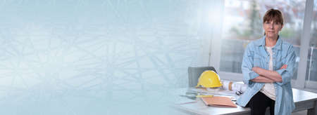 Portrait of middle aged female architect looking at the camera; panoramic banner
