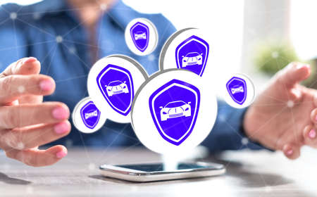 Smartphone with sports car insurance concept between hands of a woman in background