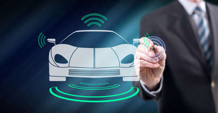 Man touching a smart car concept on a touch screen with a stylus penの写真素材