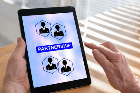Tablet screen displaying a partnership conceptの写真素材