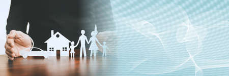 Insurer protecting a family, a house and a car with his hands; panoramic banner