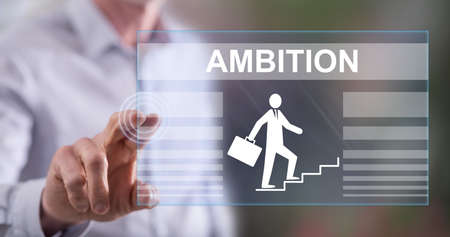 Man touching an ambition concept on a touch screen with his fingerの写真素材