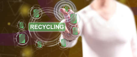 Woman touching a recycling concept on a touch screen with her fingersの写真素材
