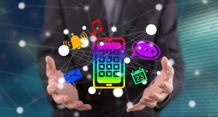 Apps concept above the hands of a man in background