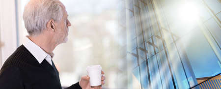Thoughtful senior businessman looking out of window during coffee break; multiple exposureの写真素材
