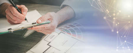 Architect working on a project in office; panoramic banner
