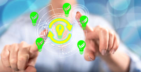 Woman touching a renewable energy concept on a touch screen with her fingers