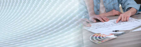 Architects working on sketch of new construction project; panoramic banner