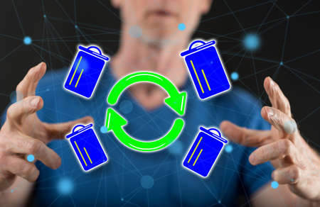 Recycling concept between hands of a man in background