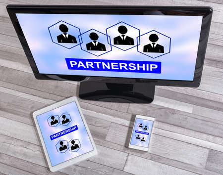 Partnership concept shown on different information technology devicesの写真素材