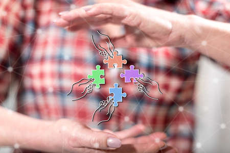 Teamwork concept between hands of a woman in backgroundの写真素材
