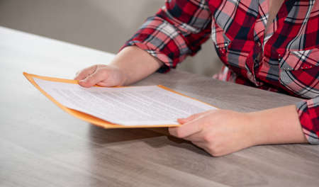 Woman reading and checking a document