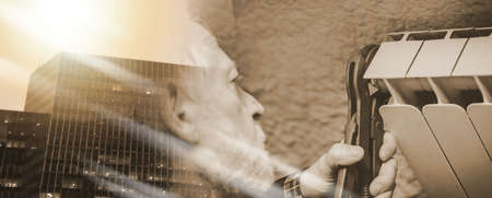 Repairman working on radiator with wrench; multiple exposureの写真素材