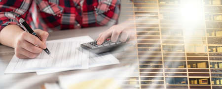 Woman using calculator and working on financial data; multiple exposure