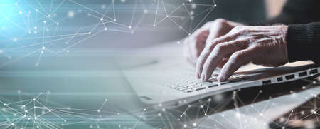 Male hands typing on laptop keyboard; panoramic banner