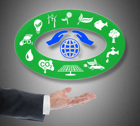Environment protection concept levitating above a hand on gray background