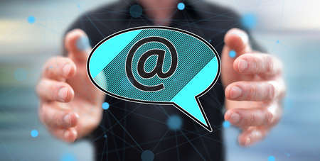 E-mail concept between hands of a man in background