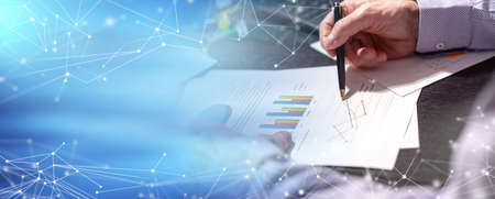 Businessman working on charts at office; panoramic banner